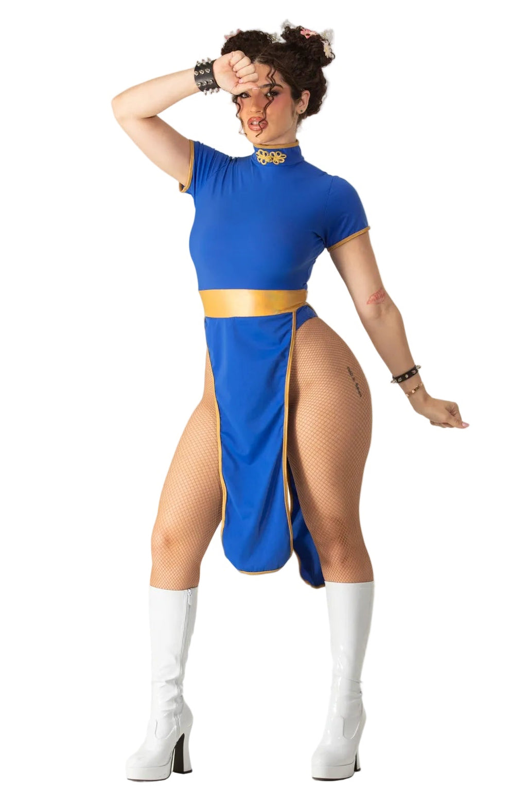A woman modeling a blue and gold Street Fighter-inspired costume dress with fishnet thigh-high stockings and white high-heeled boots, posed against a plain white background.